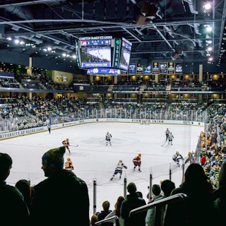 Fans watch a college hockey game between the University of Notre Dame and Minnesota at Compton Famil…
