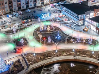 Aerial shot of Mishawaka Ironworks ice skating facility at night with holiday lights