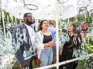 Patrons at the Rebel Art Fest look at art items.