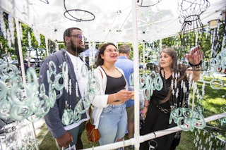 Patrons at the Rebel Art Fest look at art items.