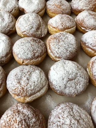 A bunch of traditional Polish filled doughnuts without a hole