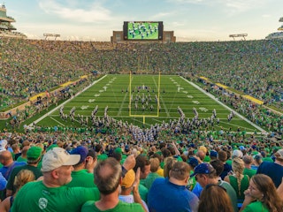 Notre Dame Stadium filled on gameday with the band marching onto the field