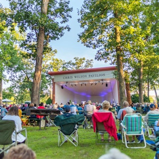 Visitors enjoy an outdoor concert at the Chris Wilson Pavilion in Potawatomi Park