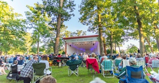 Visitors enjoy an outdoor concert at the Chris Wilson Pavilion in Potawatomi Park