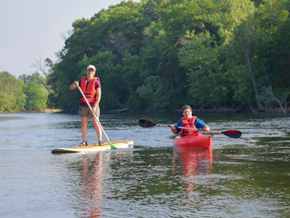 Visitors enjoy a kayak and paddle board at St. Patrick's County Park
