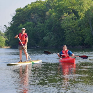 Visitors enjoy a kayak and paddle board at St. Patrick's County Park