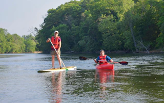 Visitors enjoy a kayak and paddle board at St. Patrick's County Park