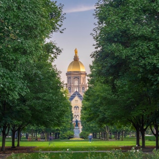 Students walking to class with the Golden Dome in the background