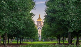 Students walking to class with the Golden Dome in the background