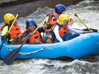 A kayak of four people go down the East Race Waterway in downtown South Bend