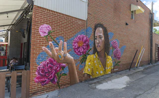 "Let It Grow" mural on the side of Hammer & Quill in the East Bank Village of Downtown South Bend.