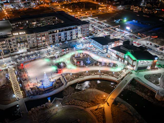 Aerial shot of Mishawaka Ironworks ice skating facility at night with holiday lights