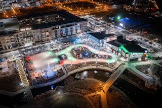 Aerial shot of Mishawaka Ironworks ice skating facility at night with holiday lights