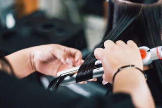 A close up shot of hair being styled at a salon